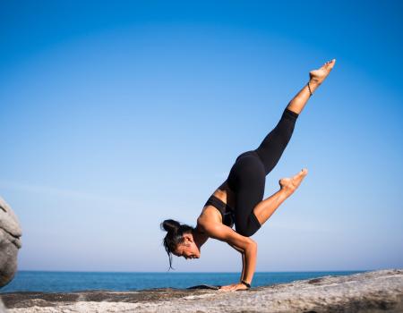 yoga on rock at lake