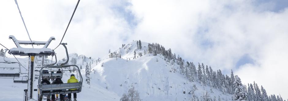 Skiers on a ski lift in Squaw Valley