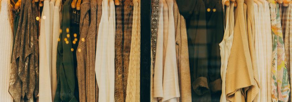 Clothes on a hanging rack at a boutique