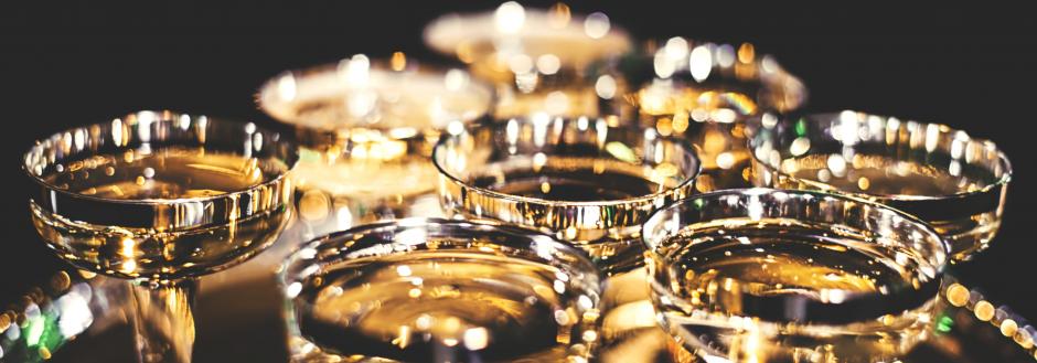 Golden champagne glasses lined up for a New Years toast