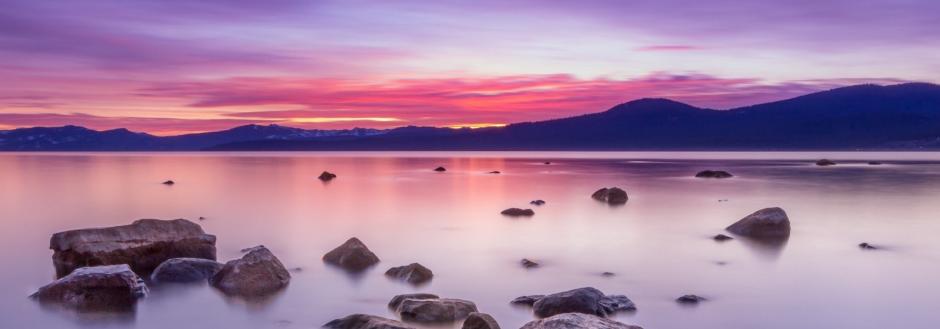 Lake Tahoe at sunset with vibrant pinks and purples in the sky