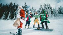 Skiers and snowboarders dressed in holiday attire