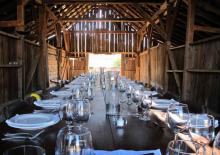 Farm to table dinner settings in a rustic barn