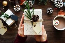 Beautifully wrapped holiday gift with a pinecone on top