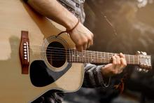 Performer playing a guitar